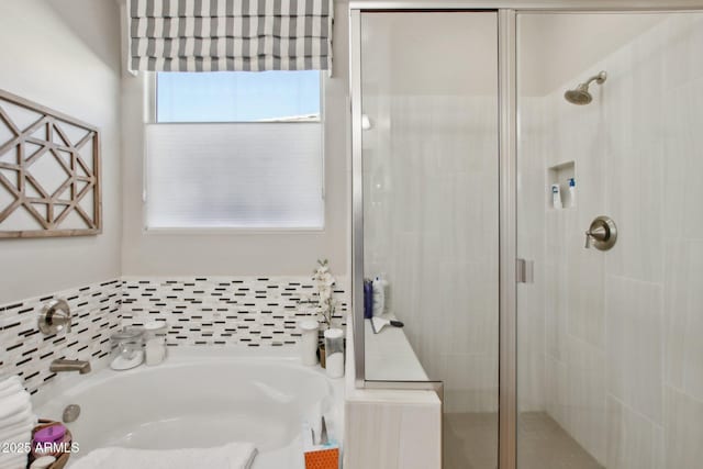 bathroom featuring shower with separate bathtub