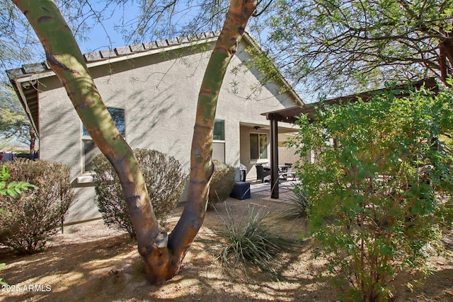 view of side of property with a patio