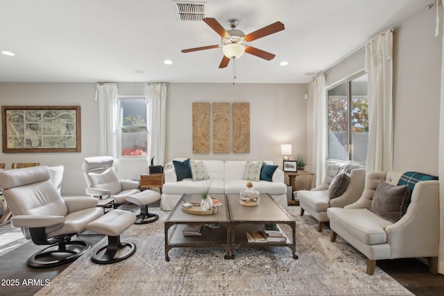 living room featuring hardwood / wood-style flooring and ceiling fan