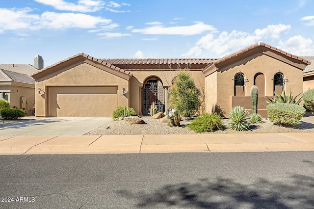 mediterranean / spanish-style home with a garage