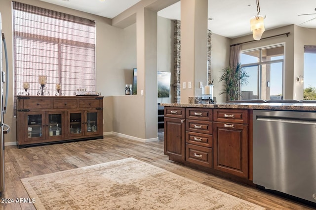 bar featuring dark brown cabinetry, ceiling fan, stainless steel dishwasher, and light wood-type flooring