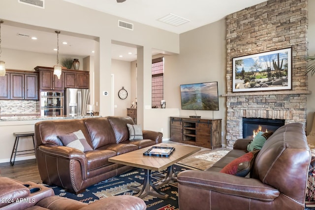 living room with a fireplace and dark wood-type flooring