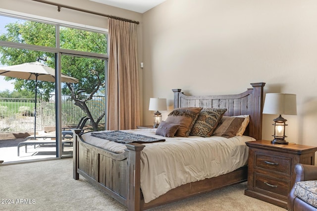 bedroom featuring light colored carpet and access to outside