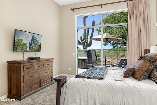 bedroom with access to outside and light colored carpet