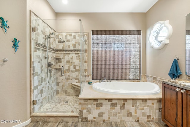 bathroom featuring separate shower and tub and vanity