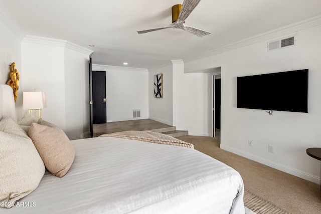 carpeted bedroom featuring visible vents, baseboards, and ornamental molding