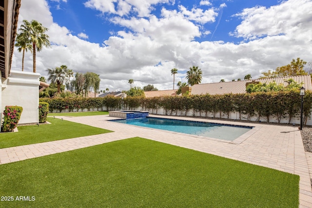 view of swimming pool with a patio area, a lawn, and a pool with connected hot tub