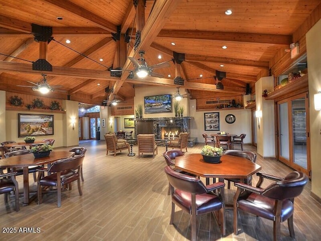 9675 E Cinnabar Ave, Scottsdale, AZ 85258 - dining area featuring wood ceiling with exposed beams, a fireplace, wood finished floors, ceiling fan, and high vaulted ceiling