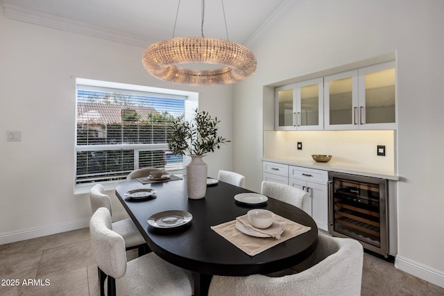 dining area featuring crown molding, baseboards, beverage cooler, a dry bar, and light tile patterned flooring