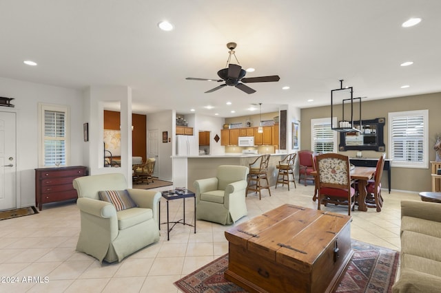 living room featuring ceiling fan and light tile patterned floors