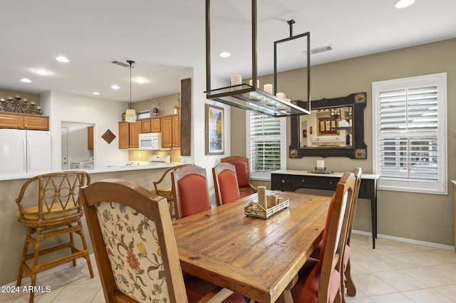 dining area featuring light tile patterned flooring