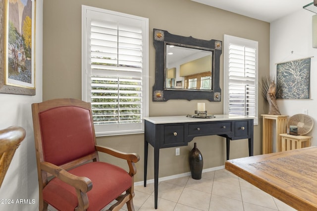 sitting room featuring light tile patterned flooring and a healthy amount of sunlight