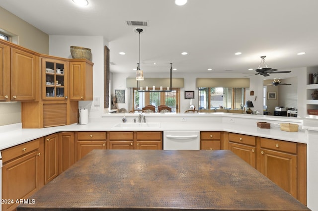 kitchen featuring dishwasher, pendant lighting, ceiling fan, and sink