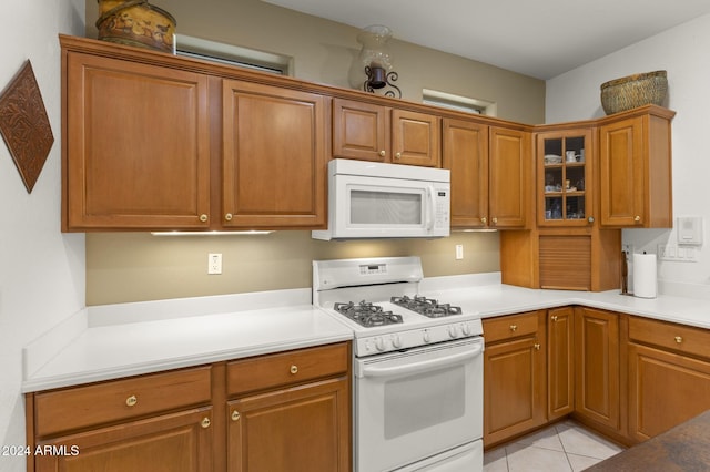 kitchen featuring white appliances and light tile patterned floors