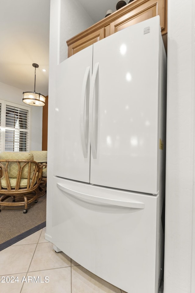 details with light tile patterned floors and white fridge