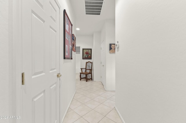 corridor featuring light tile patterned floors