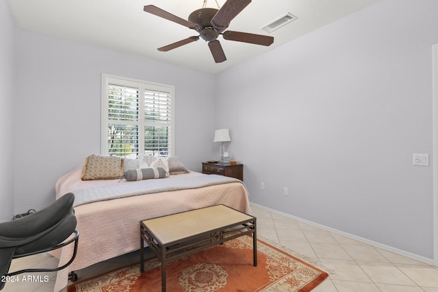 tiled bedroom featuring ceiling fan