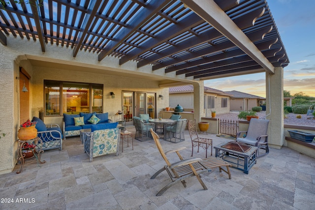 patio terrace at dusk featuring an outdoor hangout area and a pergola