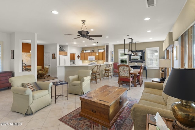 living room with ceiling fan and light tile patterned floors