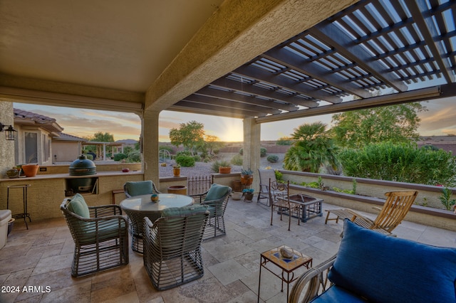 patio terrace at dusk featuring a pergola