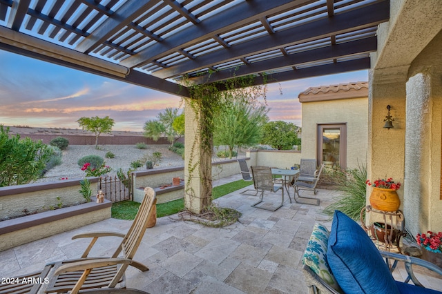 patio terrace at dusk featuring a pergola