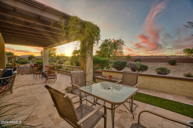 view of patio terrace at dusk