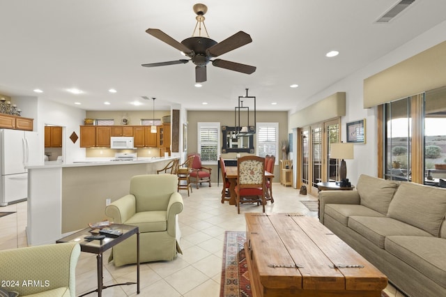 living room featuring ceiling fan and light tile patterned floors