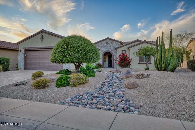 mediterranean / spanish-style home featuring a garage