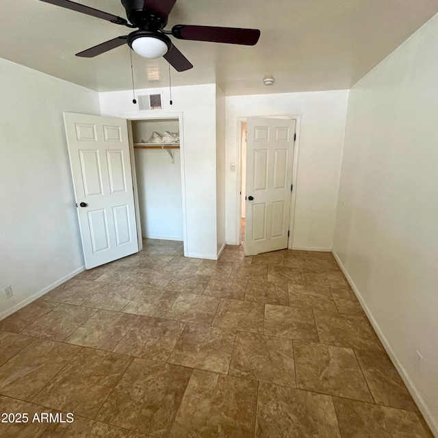 4118 N 3rd Ave, Phoenix, AZ 85013 - unfurnished bedroom featuring baseboards, stone finish flooring, a closet, and a ceiling fan