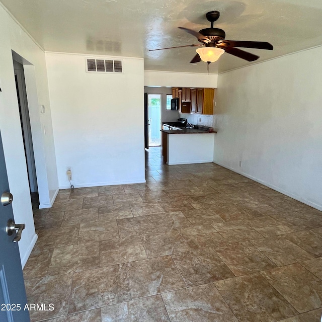 4118 N 3rd Ave, Phoenix, AZ 85013 - unfurnished living room with ceiling fan, stone finish floors, and baseboards