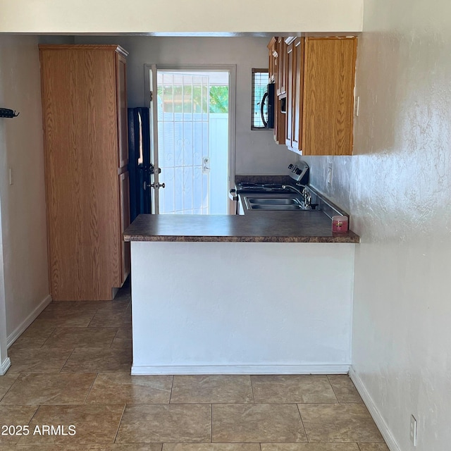 4118 N 3rd Ave, Phoenix, AZ 85013 - kitchen with dark countertops, baseboards, a sink, and black microwave