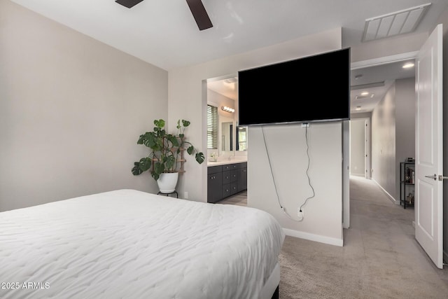 bedroom featuring light carpet, baseboards, visible vents, ceiling fan, and ensuite bathroom