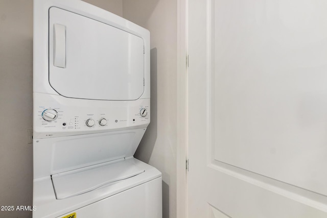 washroom with laundry area and stacked washer / dryer