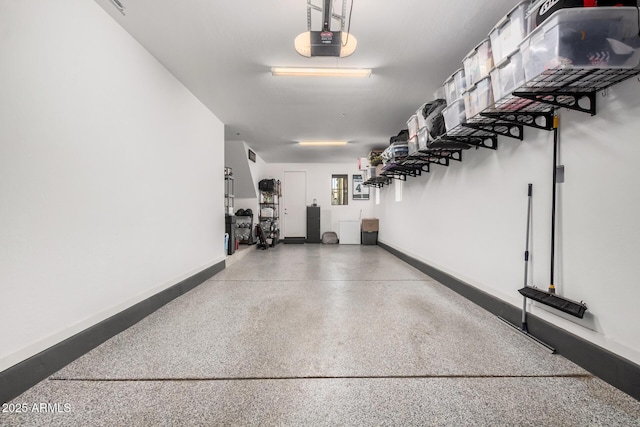 garage with baseboards and a garage door opener