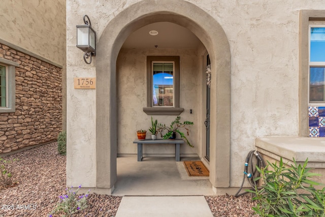 view of exterior entry featuring stucco siding