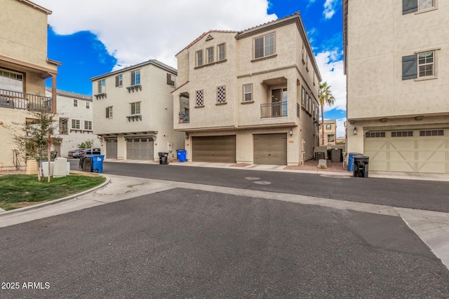 view of front of home with a garage, central air condition unit, and stucco siding