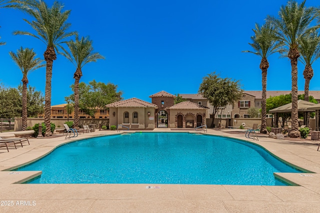 community pool featuring fence, a patio, and a gazebo