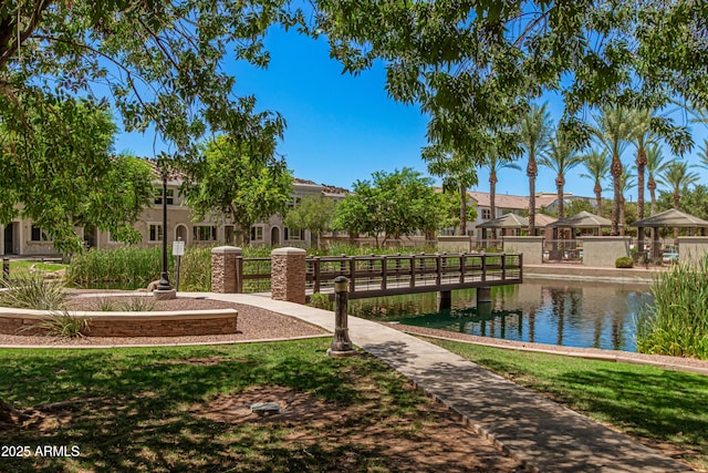 surrounding community featuring a water view, a residential view, and a yard