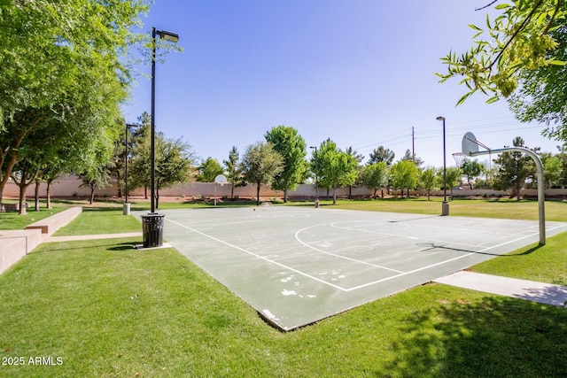 view of basketball court with community basketball court and a lawn