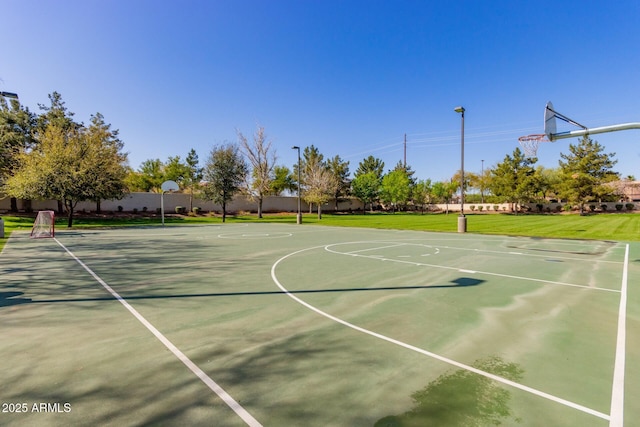 view of basketball court with community basketball court, a yard, and fence