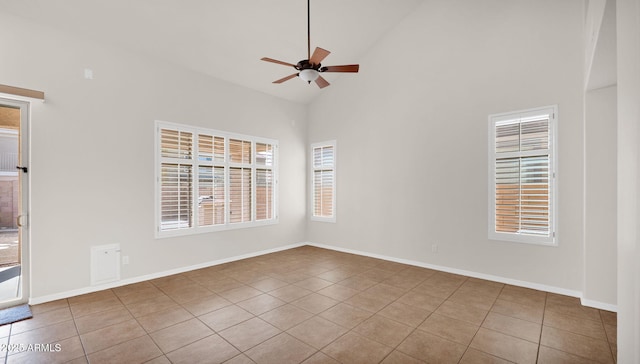 tiled spare room with a ceiling fan, high vaulted ceiling, and baseboards