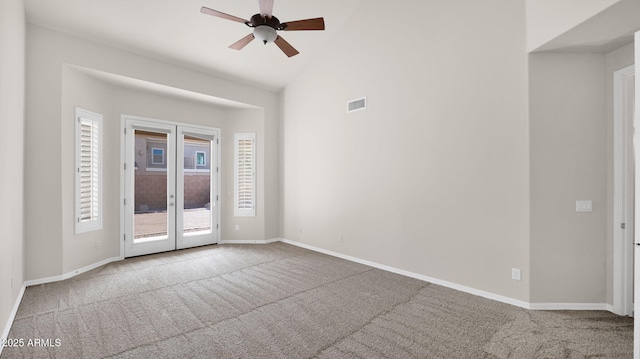 carpeted empty room featuring a healthy amount of sunlight, baseboards, and french doors