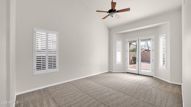 unfurnished room with carpet floors, high vaulted ceiling, ceiling fan, and baseboards