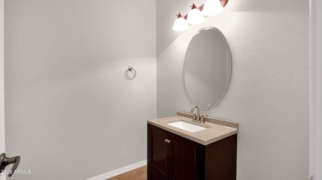 bathroom with vanity and baseboards