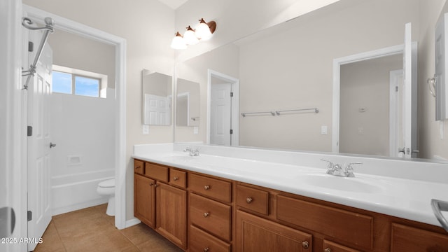 full bath featuring tile patterned flooring, a sink, toilet, and double vanity