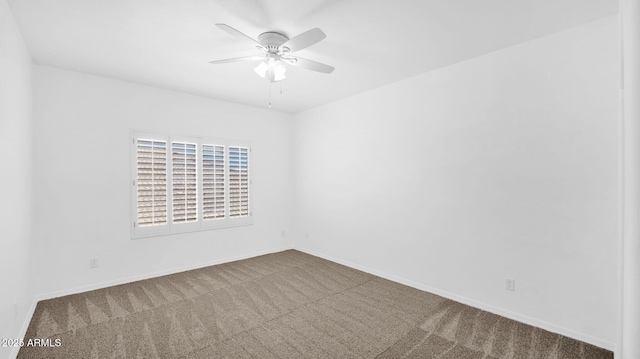 spare room with carpet, baseboards, and ceiling fan
