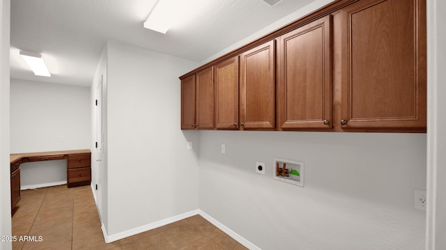 clothes washing area featuring washer hookup, light tile patterned floors, cabinet space, electric dryer hookup, and baseboards