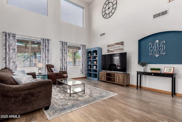 16210 W Durango St, Goodyear, AZ 85338 - living area featuring wood finished floors and a towering ceiling
