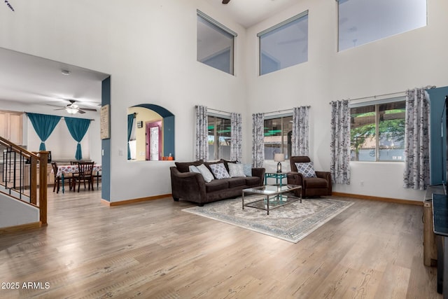 16210 W Durango St, Goodyear, AZ 85338 - living area featuring a ceiling fan, wood finished floors, a towering ceiling, and stairway