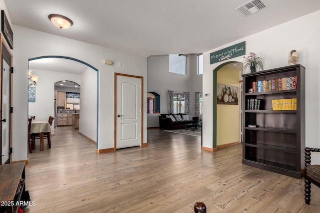 16210 W Durango St, Goodyear, AZ 85338 - foyer entrance with arched walkways and light wood-style floors